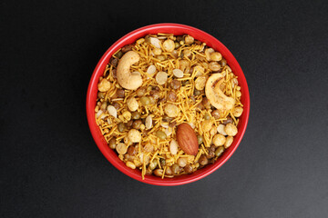 Dal moth in a white bowl, made with roasted Masoor Dal black lentils Pile of Indian spicy snacks Namkeen