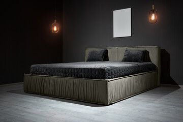 Double bed in a gray color with a soft velor headboard in a loft-style bedroom