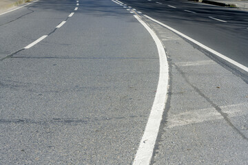 Road strip, line  asphalt texture close up. sign on asphalt 