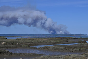 smoke plume on blue sky background