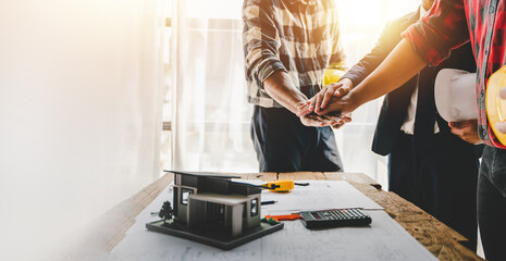 engineering team shaking hands start planning for architecture Engineer sketching construction project concept with architect equipment Consult about their construction project.