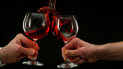 Naklejka na ściany i meble Two men clinking with glasses of red wine, celebrating success.
