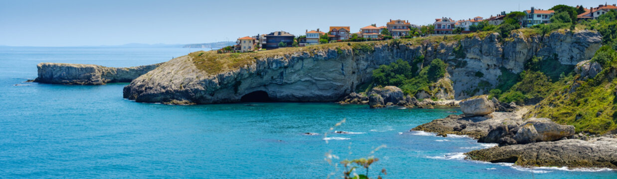 Istanbul, Turkey. The rocky shore of the Black Sea with a cave in Shila, beautiful villas on a hill.