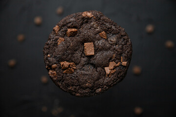 American chocolate chip cookies with chocolate on a dark background. Delicious dessert, close-up