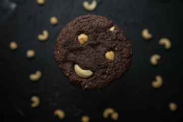 American chocolate chip cookies with nuts on a dark background. Delicious dessert, close-up