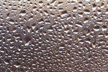 Drops on the glass in the sunset glow