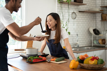 Couple cooking together. Happy young couple cooking together in the kitchen. valentine day concept.