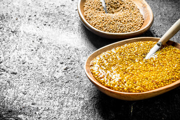 Mustard on plates with spoons.