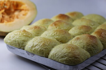 Pumpkin dinner rolls. Soft and buttery dinner rolls made with pumpkin puree inside the baking tray fresh from oven