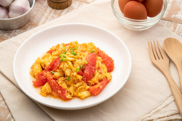 Stir fried egg with tomato,Scrambled eggs with tomatoes on white plate
