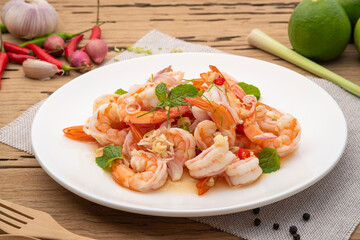 Spicy salad with shrimp,Thai boiled shrimps with lemongrass in chilli lime sauce in white plate