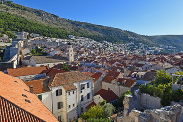 view of many landmarks of the old town in the city of Dubrovnik, Croatia with classic red tiled rooftops