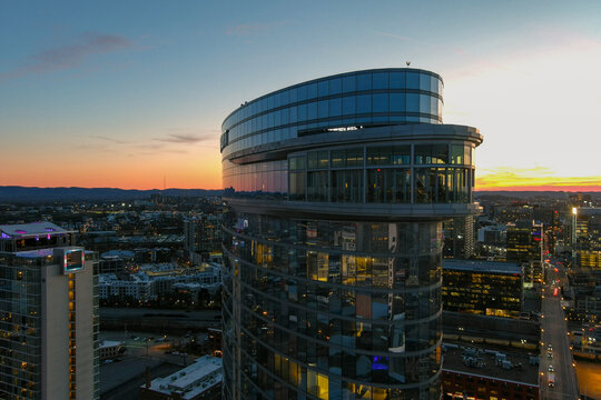 aerial shot of the JW Marriott building and office buildings in the city skyline at sunset with cars driving on the street on the riverfront and a gorgeous blue sky with clouds in Nashville Tennessee