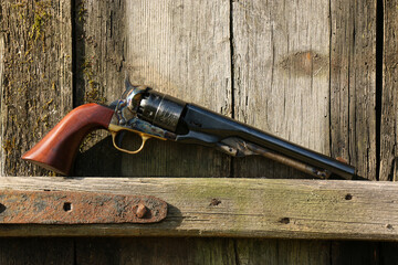 Black powder revolver Colt Army on an old board.