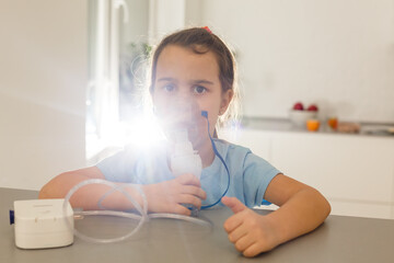 Little girl use inhaler nebulizer. Child asthma inhaler, nebulizer steam, flu or cold concept. Copyspace