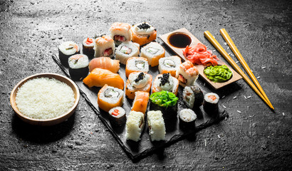 The range of different types of sushi, rolls and Maki with sauces and chopsticks.