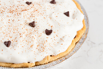 Chocolate Cream Pie Topped with Chocolate Chips and Cocoa on Cream