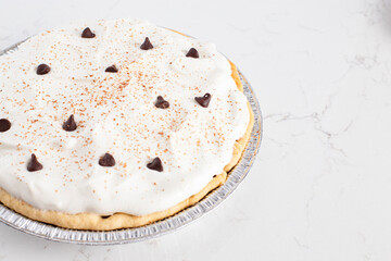 Chocolate Cream Pie Topped with Chocolate Chips and Cocoa on Cream