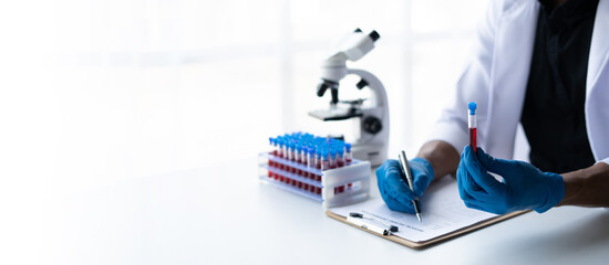 Blood test tubes. Senior male scientist examining blood test tubes at his laboratory dna testing. copy space.