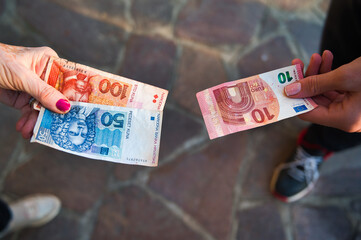 Money in hand, croatian kuna and euro, the concept of Croatians joining the euro zone, exchanging banknotes, changing the currency system
 - obrazy, fototapety, plakaty