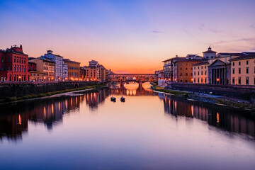 Famous Ponte Vecchio bridge on the river Arno River at sunset, Florence, Italy