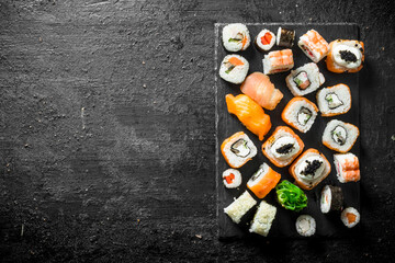Set of different sushi rolls with salmon, chicken, shrimp and vegetables.