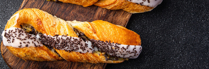 bun sweet puff pastry pigtail bun cream filling, chocolate drops meal food snack on the table copy space food background rustic top view