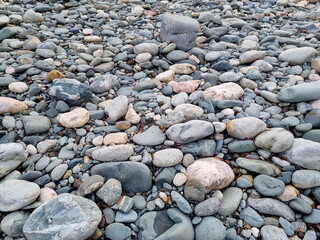 water-sharpened stones on the bank of a mountain river. natural building material for landscape design in the park.