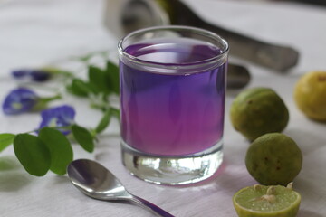 Pink coloured butterfly pea flower tea. Blue colored butterfly pea flower tea changes color to pink when lemon juice is added.