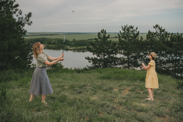 mom and daughter play badminton in the field