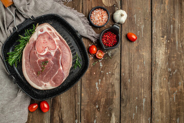 Raw pork leg on a wooden background, banner, menu, recipe place for text, top view