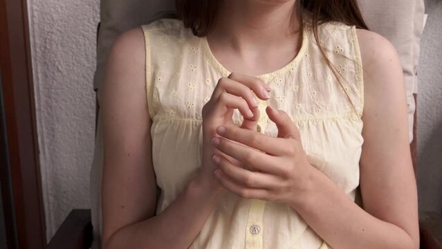 Teenage girl practicing EFT or emotional freedom technique - tapping on the side of the hand