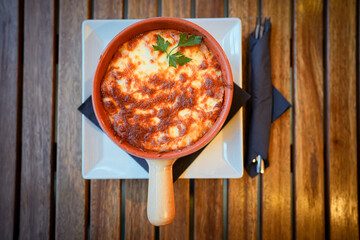 Freshly baked lasagna in a round pot