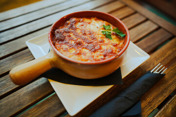 Freshly baked lasagna in a round pot