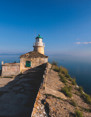 View of Old Venetian Fortress of Corfu, Palaio Frourio, Kerkyra old town, Greece, Ionian sea islands, with the lighthouse, Clock tower, st. George church and the city, a blue sky summer sunny day
