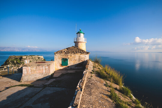 View of Old Venetian Fortress of Corfu, Palaio Frourio, Kerkyra old town, Greece, Ionian sea islands, with the lighthouse, Clock tower, st. George church and the city, a blue sky summer sunny day