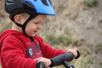 close up of toddler boy riding balance bike
