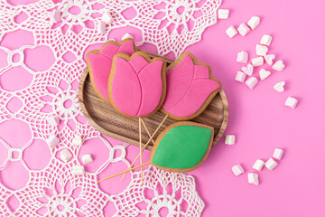 Spring gingerbread with icing on pink background. Gingerbreads in the form of a tulips. Top view