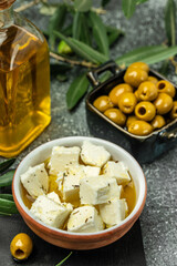 pickled feta cheese in bowl. Feta cheese marinated in olive oil. Restaurant menu, dieting, cookbook recipe top view
