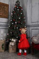 child decorating christmas tree