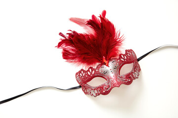 Carnival Venetian mask with red feather decoration isolated on white