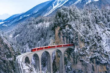 Foto auf Acrylglas Landwasserviadukt Aerial view of Train passing through famous mountain in Filisur, Switzerland. Landwasser Viaduct world heritage with train express in Swiss Alps snow winter scenery.