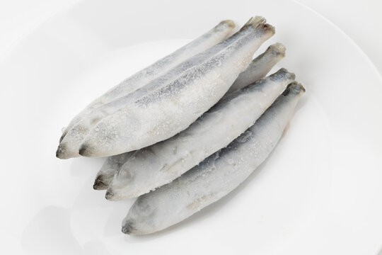 Frozen sea herring on a white background.
