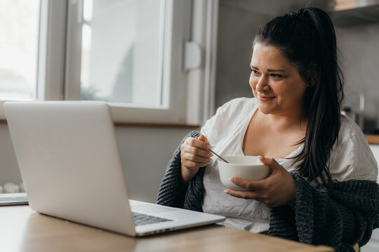 Middle aged woman works remotely from home