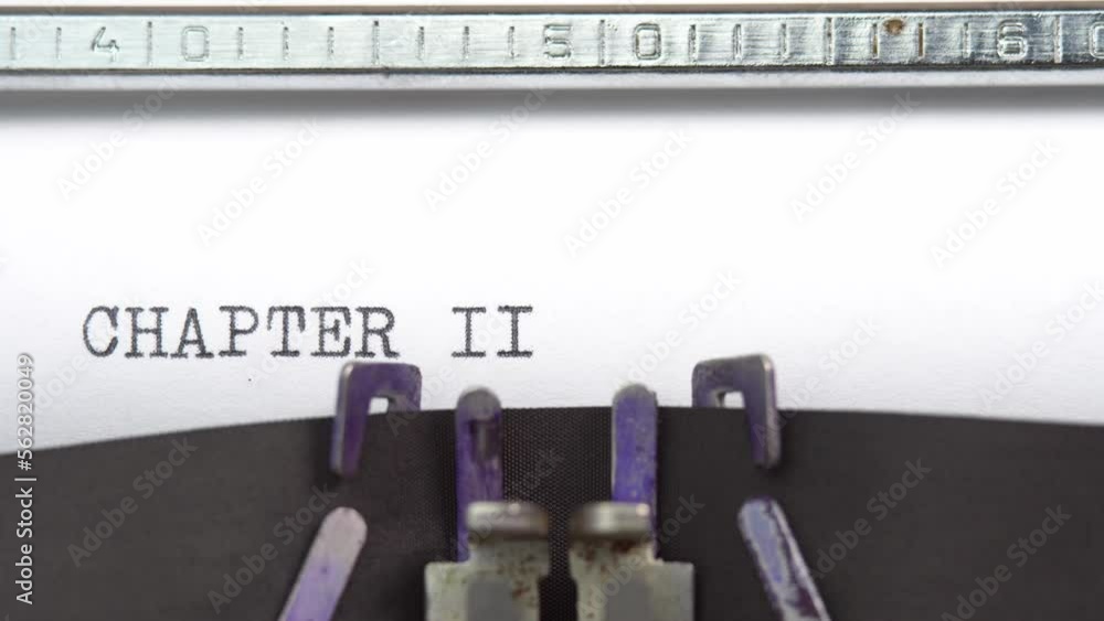 Poster chapter two phrase closeup being typing and centered on a sheet of paper on old vintage typewriter m
