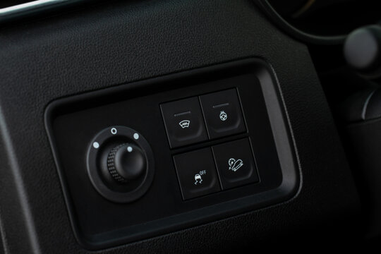 Hand operating ESP (electronic stability program) control close up view. Interior detail of a modern car. ESP button.
