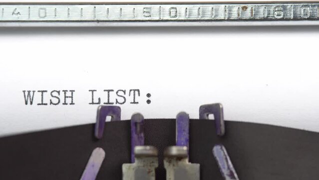 Wish List phrase closeup being typing and centered on a sheet of paper on old vintage typewriter mechanical