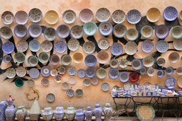 Fez, Morocco - vibrant ceramic goods on display for sale in Fes el Bali market. Cups and saucers on...