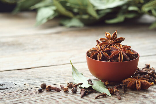 Bowl of anise stars. Gloves, laurel leaves. Ingredients for healthy cooking. Ayurveda remedies.