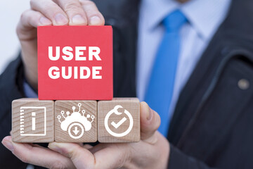 Businessman presents colorful blocks with banner: USER GUIDE. Download online user manual book.